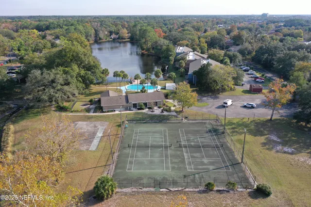 an aerial view of a house with a yard