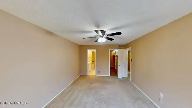 a view of a livingroom with a ceiling fan and window