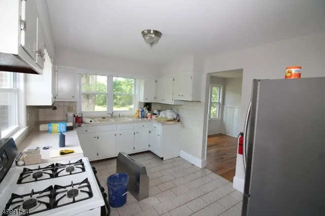 a kitchen with a sink stove and refrigerator