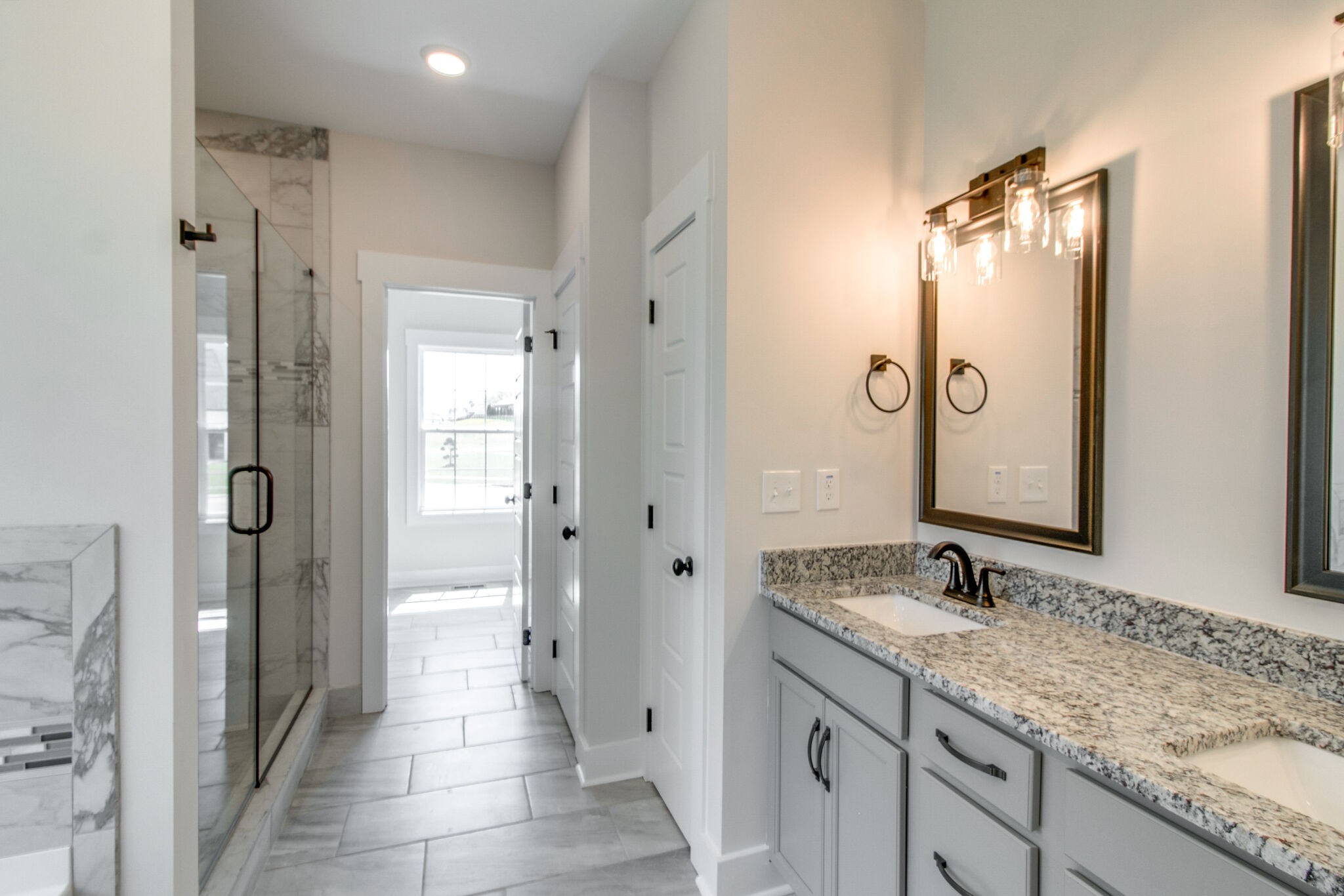 259 Harrowgate Drive Clarksville, TN 37043 - Photo 17 of 39 a bathroom with a granite countertop sink mirror and a shower