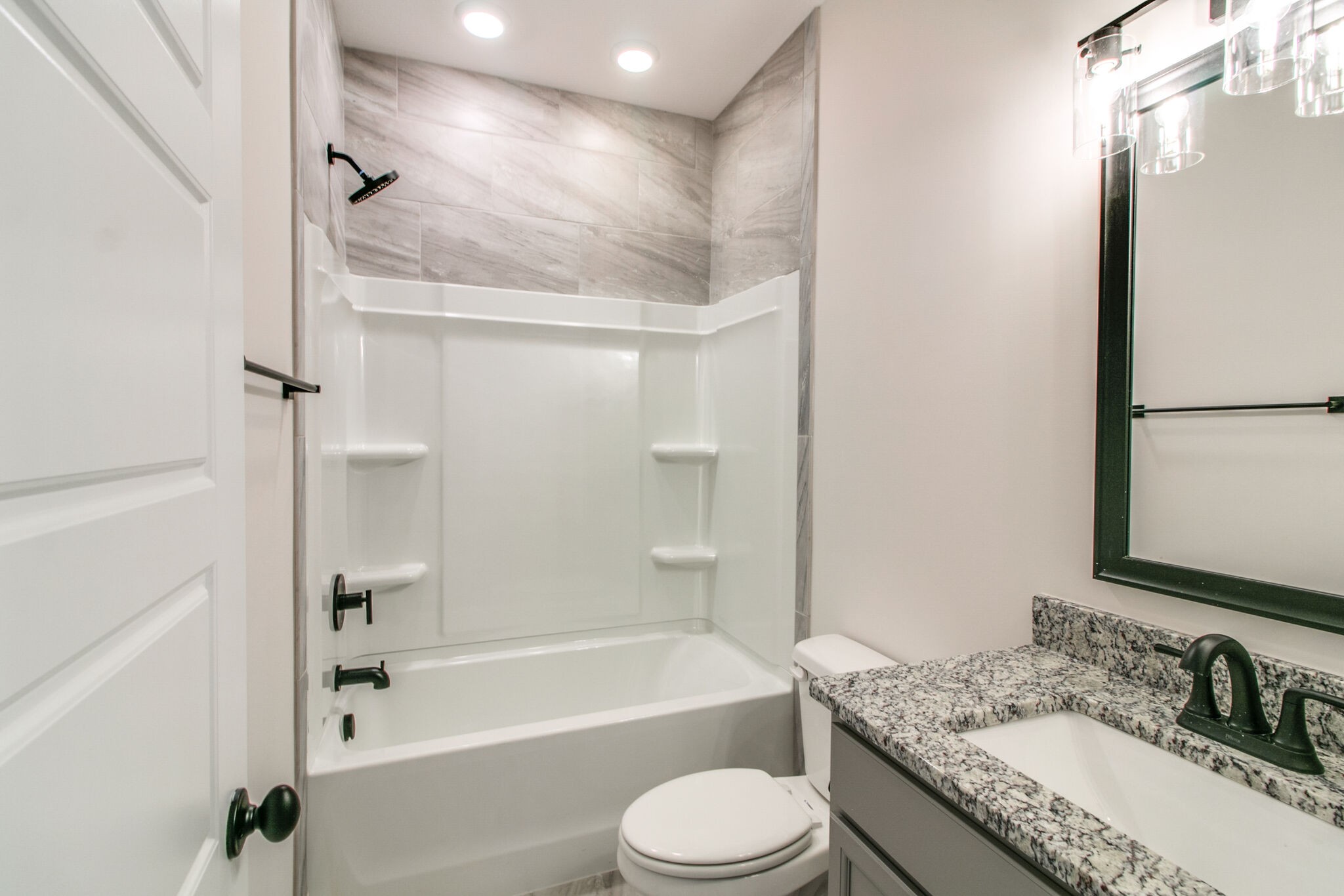 259 Harrowgate Drive Clarksville, TN 37043 - Photo 24 of 39 a bathroom with a granite countertop bathtub shower sink vanity mirror and toilet