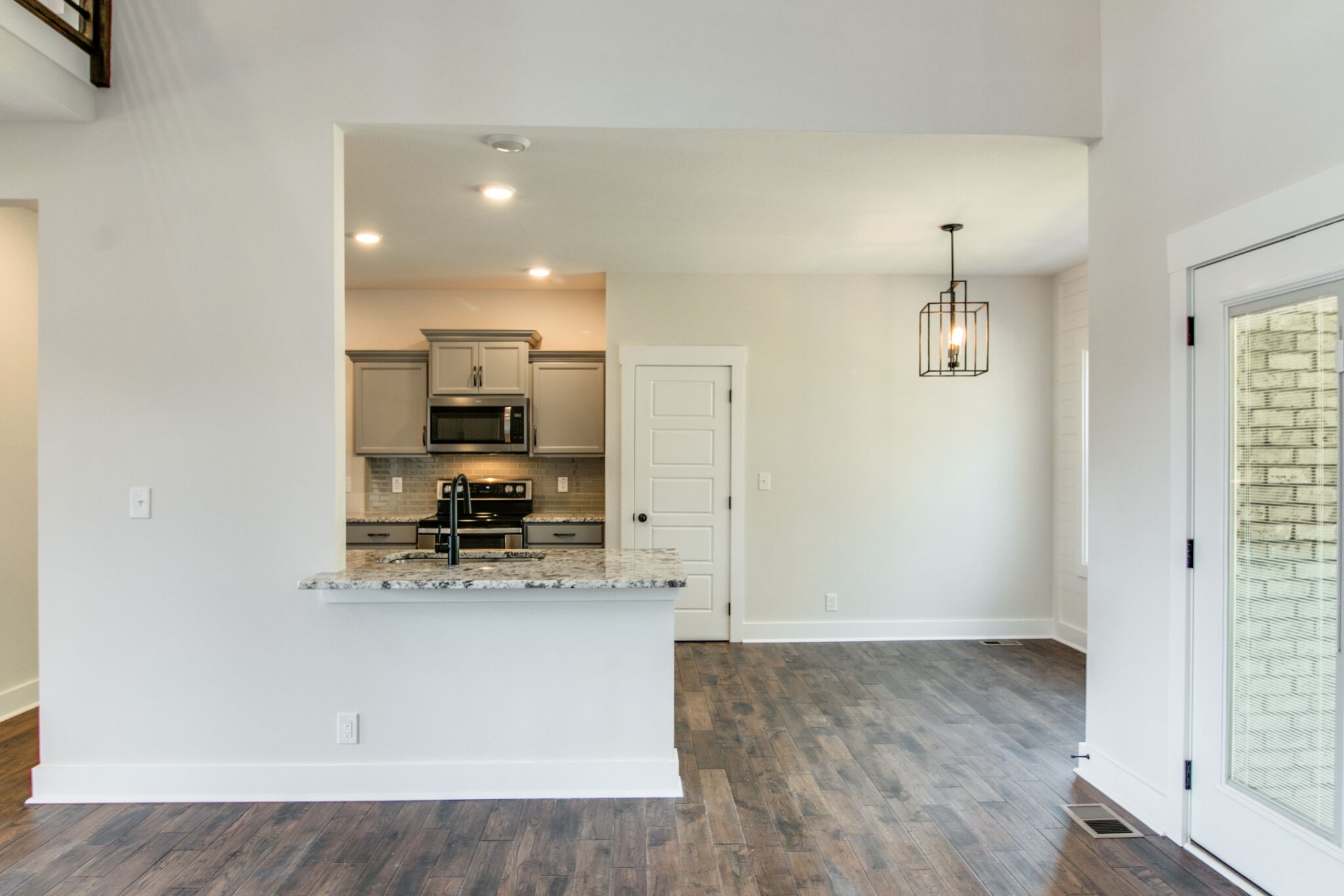 259 Harrowgate Drive Clarksville, TN 37043 - Photo 9 of 39 a view of kitchen with kitchen island stainless steel appliances wooden floor and window