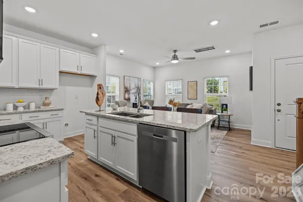 a kitchen with a sink stove and cabinets