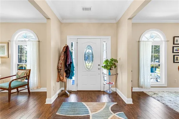 a large kitchen with kitchen island a large window cabinets and stainless steel appliances
