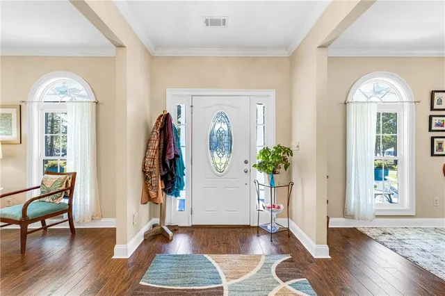 a large kitchen with kitchen island a large window cabinets and stainless steel appliances