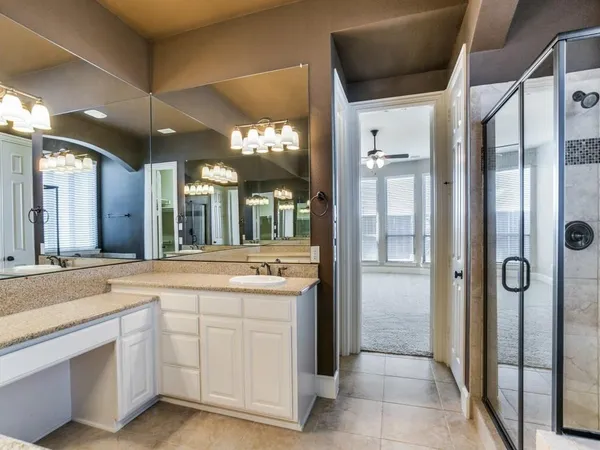 a spacious bathroom with a shower and a sink