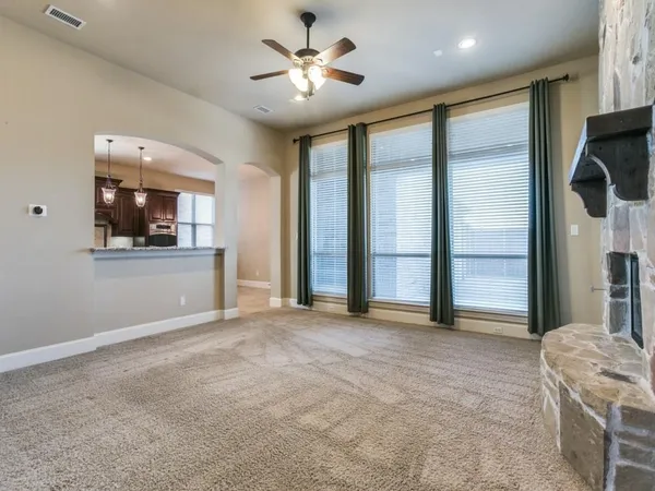 a view of an empty room with a kitchen