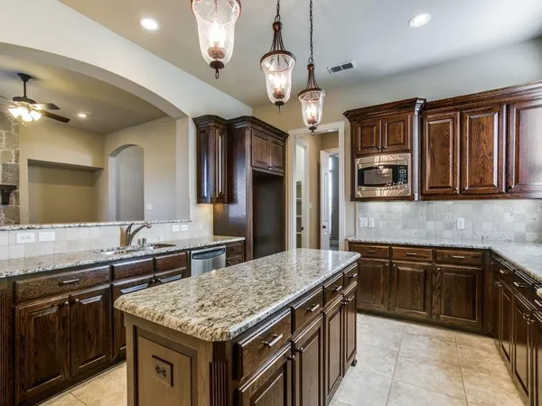 a kitchen with stainless steel appliances granite countertop a sink and stove