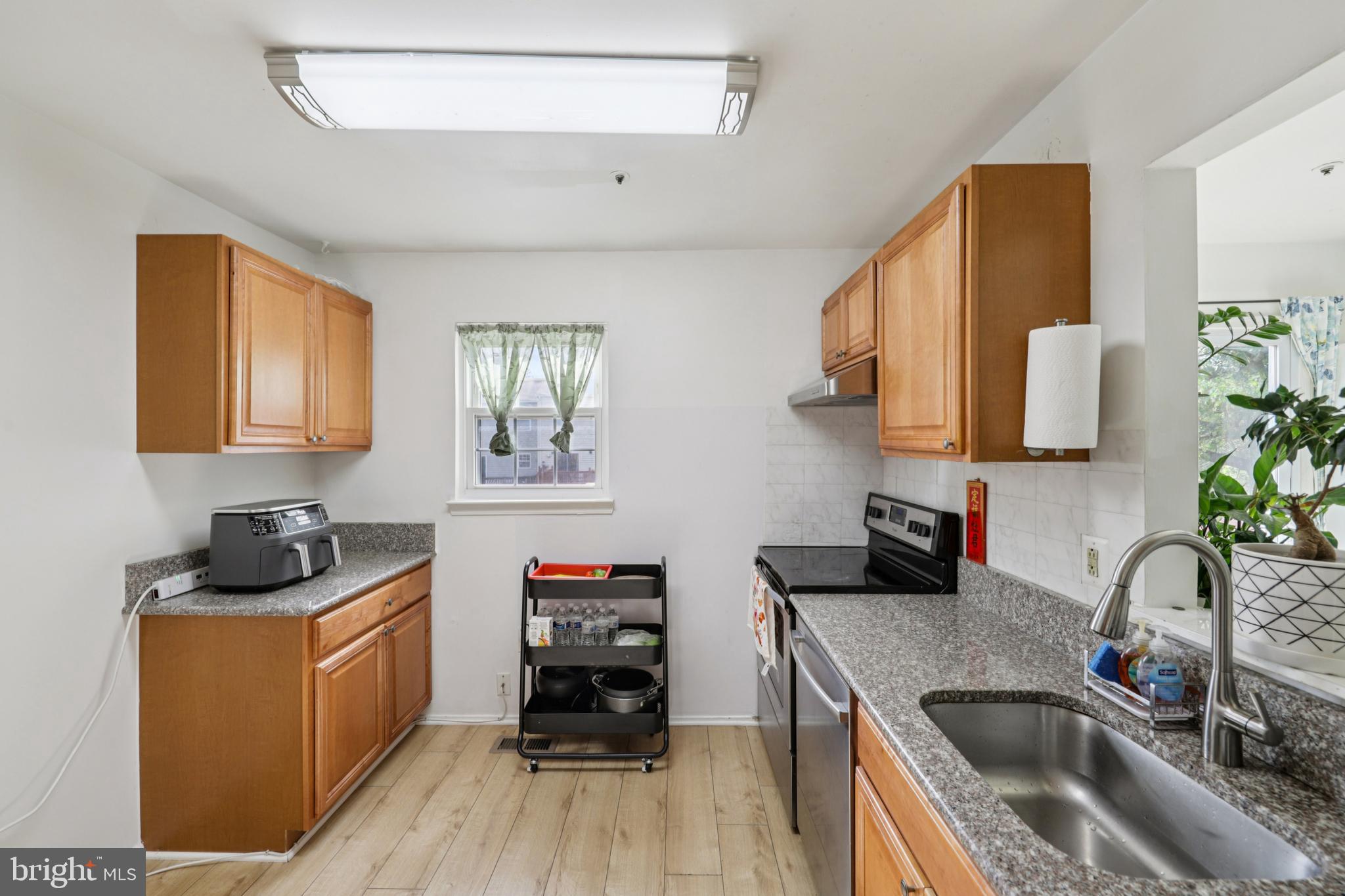 12014 Swallow Falls Court Silver Spring, MD 20904 - Photo 12 of 48 a kitchen with stainless steel appliances granite countertop a sink stove and cabinets