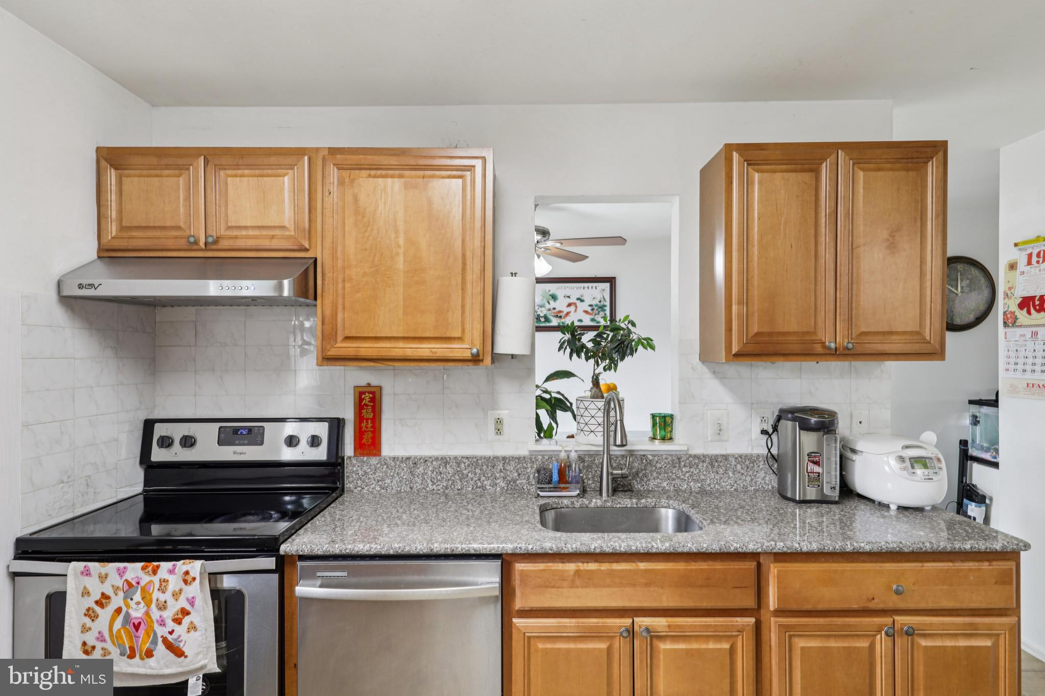 12014 Swallow Falls Court Silver Spring, MD 20904 - Photo 13 of 48 a kitchen with granite countertop stainless steel appliances a stove sink and cabinets