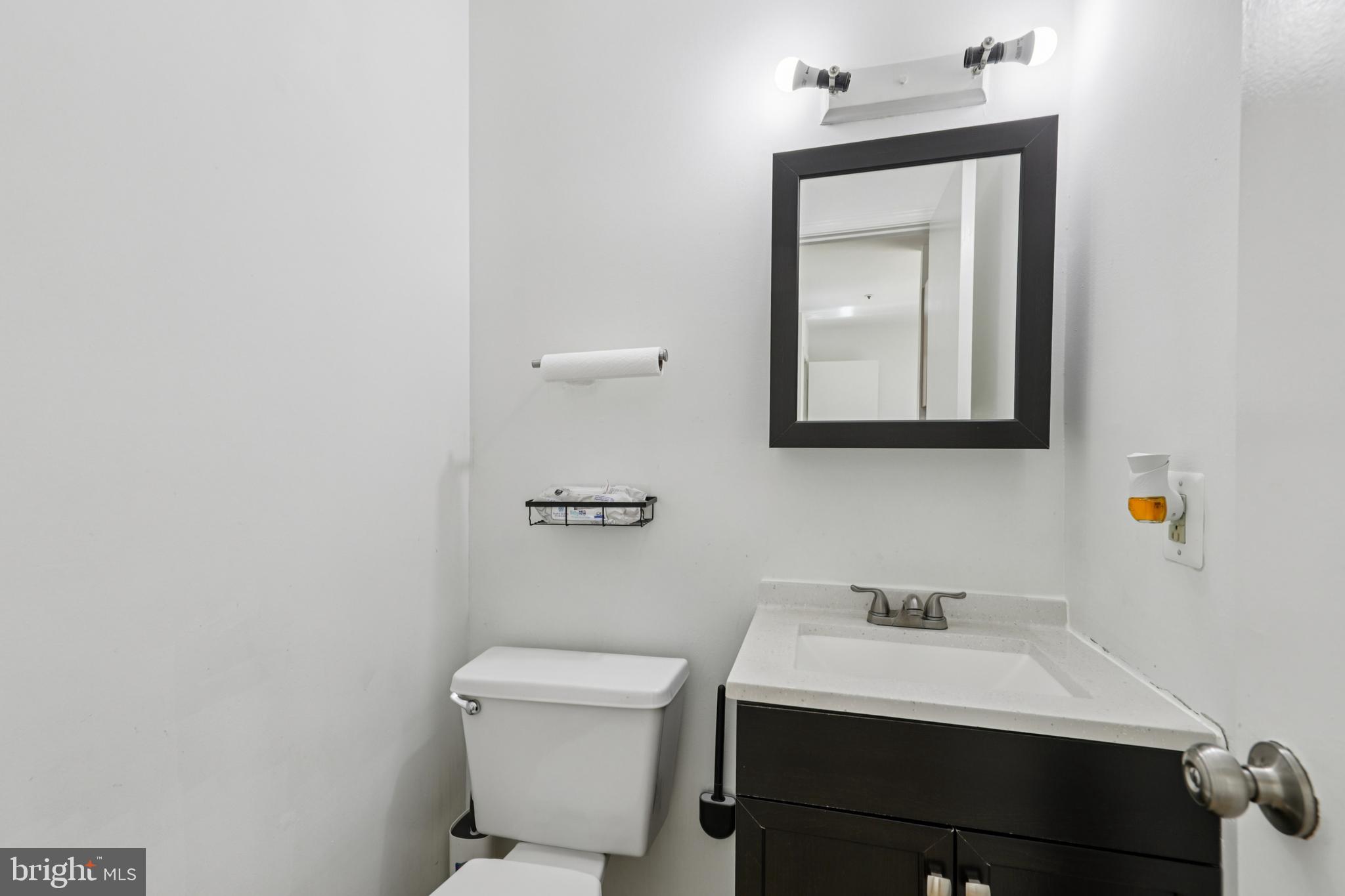 12014 Swallow Falls Court Silver Spring, MD 20904 - Photo 16 of 48 a bathroom with a toilet sink and mirror