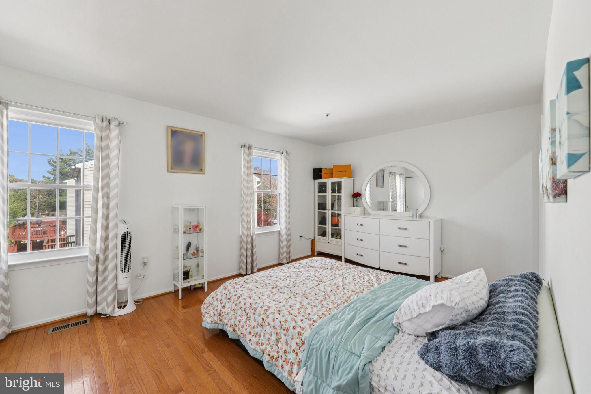 12014 Swallow Falls Court Silver Spring, MD 20904 - Photo 17 of 48 a bedroom with a bed and wooden floor