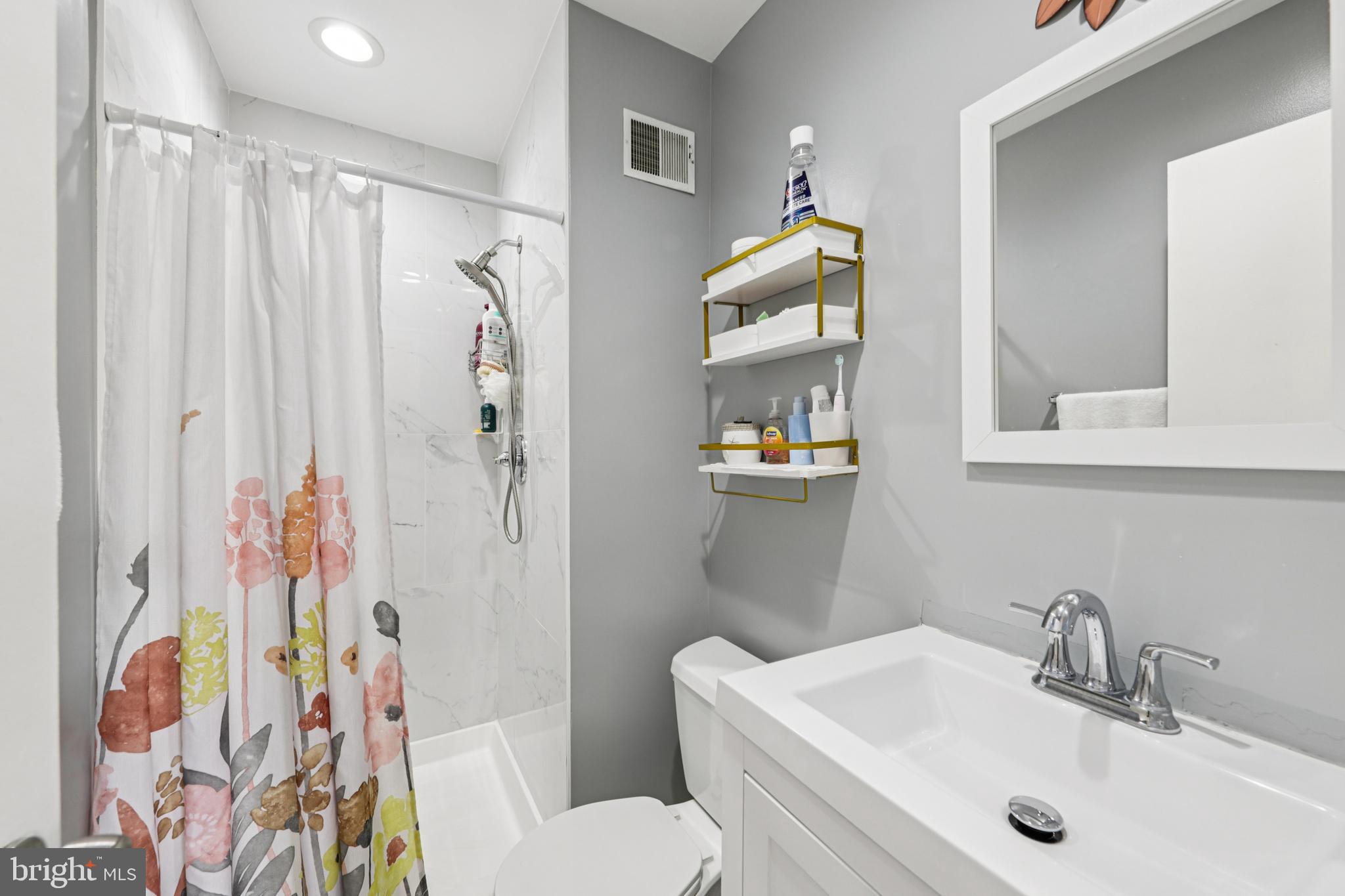 12014 Swallow Falls Court Silver Spring, MD 20904 - Photo 21 of 48 a bathroom with a sink toilet and shower