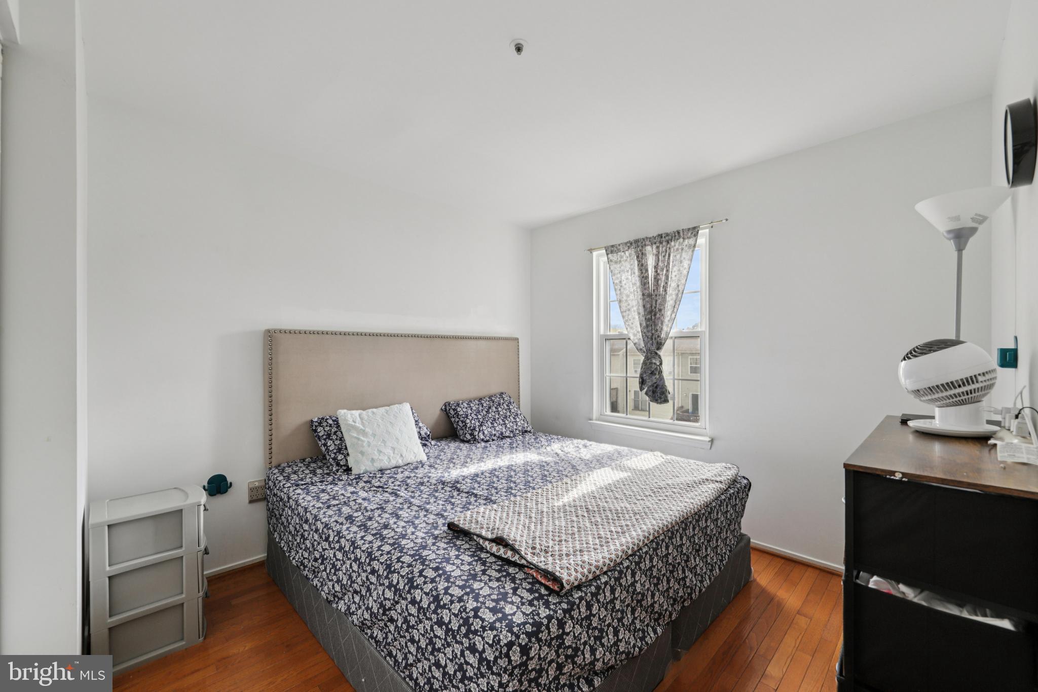 12014 Swallow Falls Court Silver Spring, MD 20904 - Photo 23 of 48 a bedroom with a bed and wooden floor