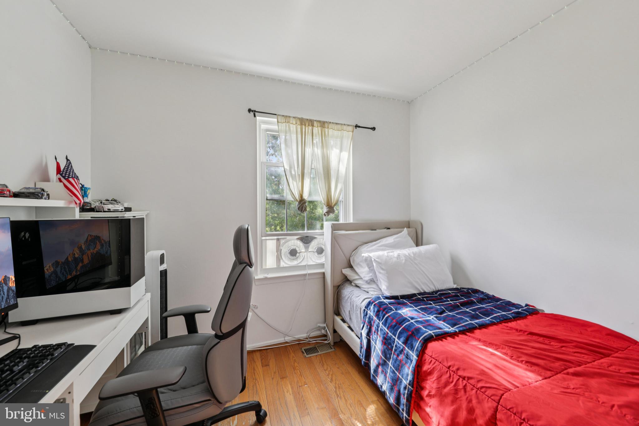 12014 Swallow Falls Court Silver Spring, MD 20904 - Photo 27 of 48 a bedroom with a bed and a chair in it