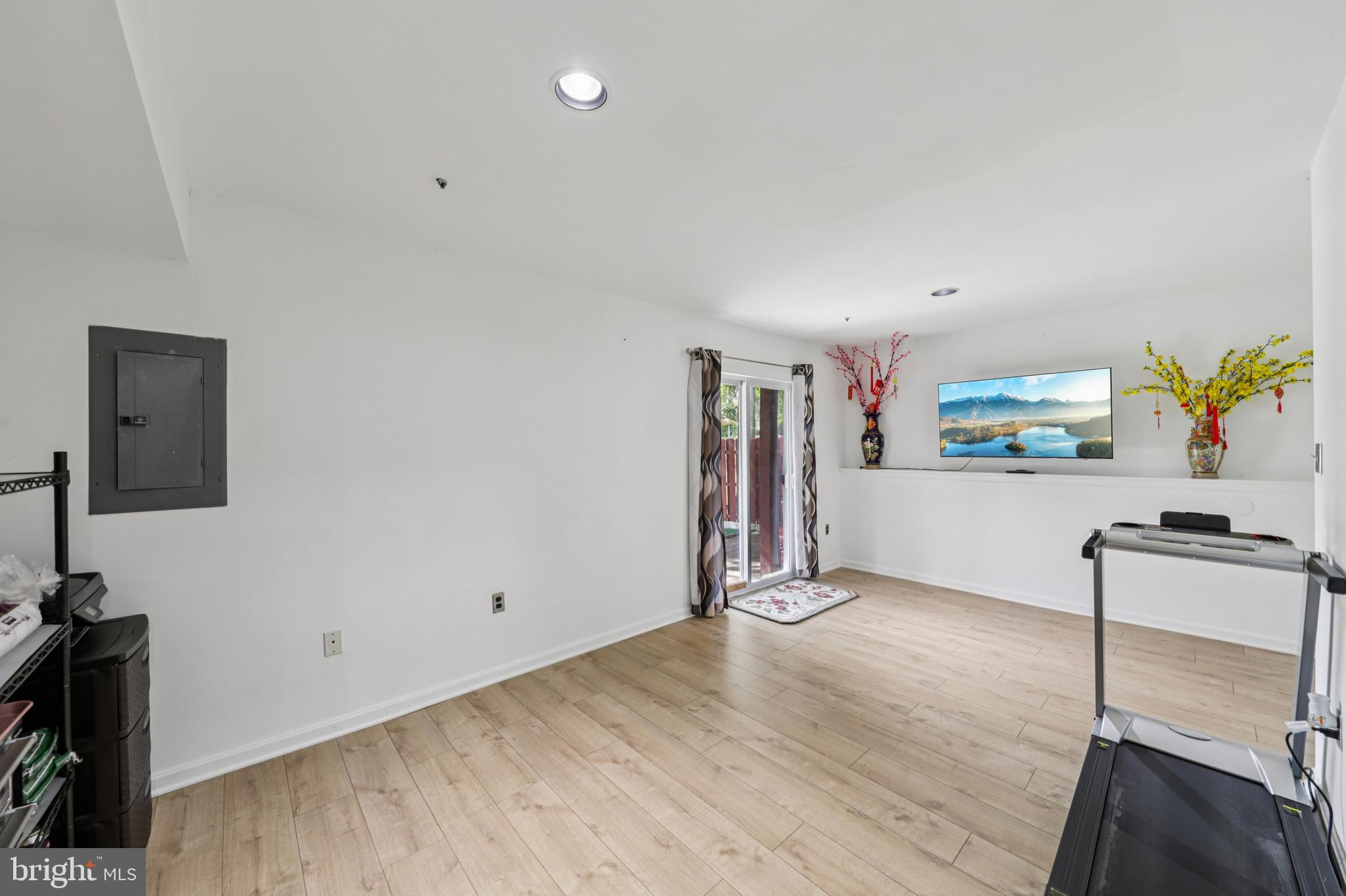 12014 Swallow Falls Court Silver Spring, MD 20904 - Photo 30 of 48 a view of a room with gym equipment and a flat screen tv