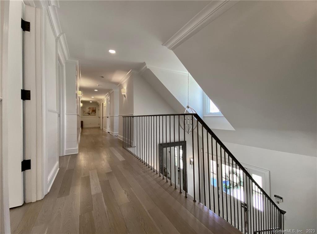 7 Whaling Road Darien, CT 06820 - Photo 17 of 34 a view of a hallway with wooden floor and staircase