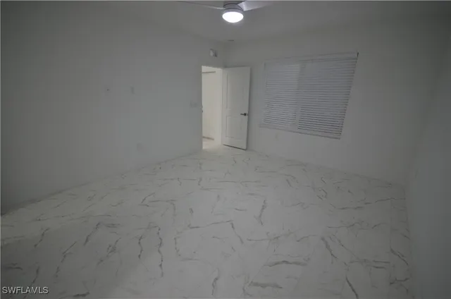 a bathroom with a granite countertop sink a mirror and shower