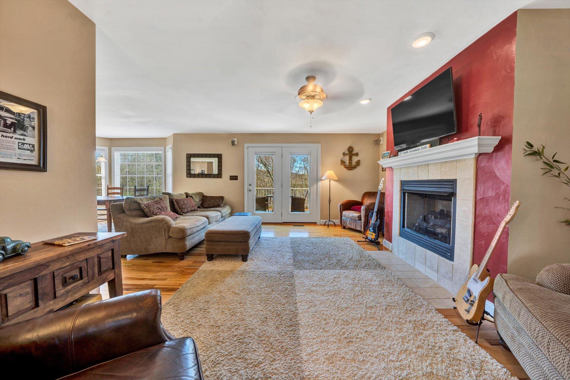 60 Green Level Road Boones Mill, VA 24065 - Photo 14 of 53 a living room with furniture a fireplace and a flat screen tv