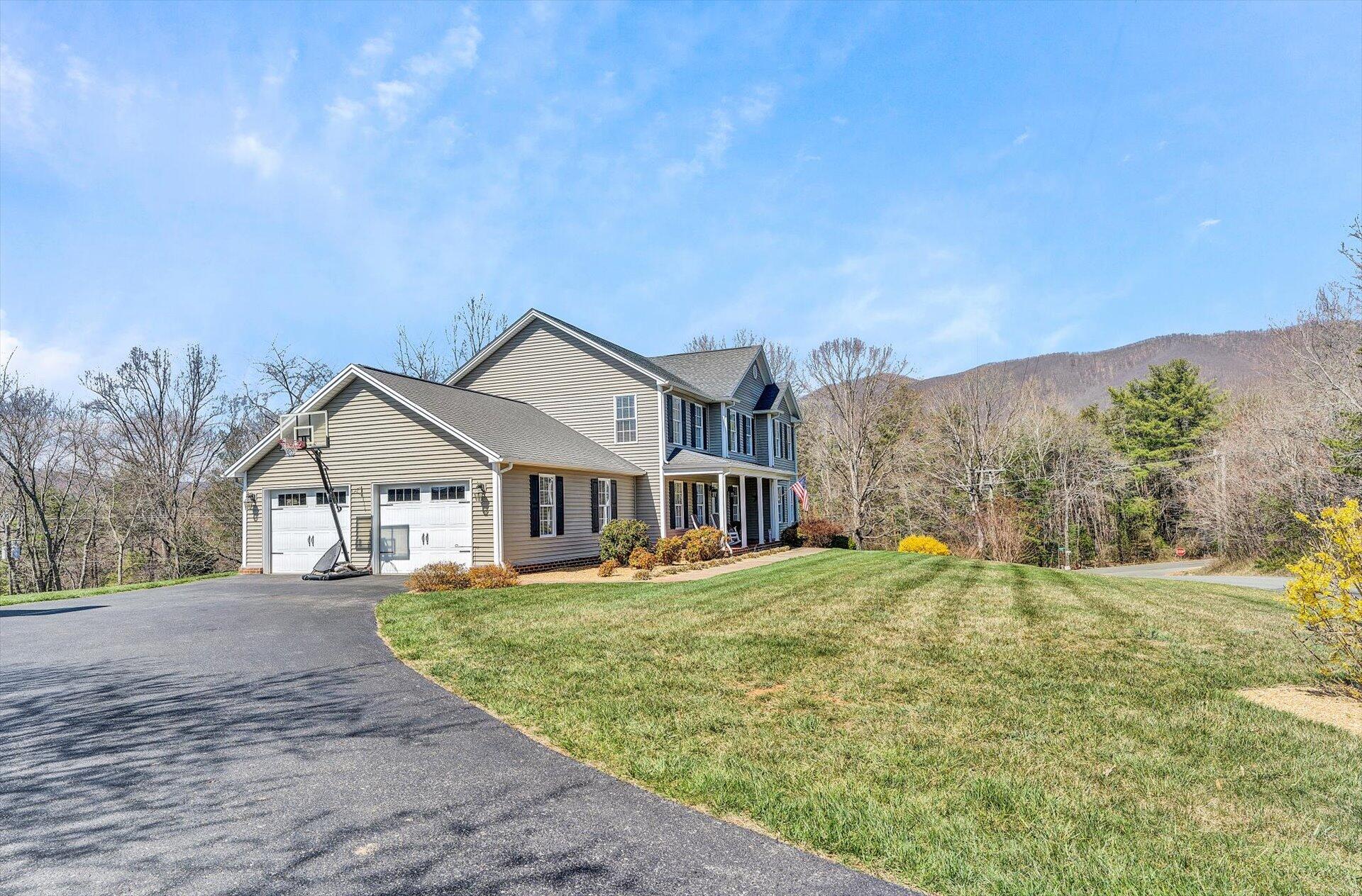 60 Green Level Road Boones Mill, VA 24065 - Photo 2 of 53 a front view of a house with a yard and trees