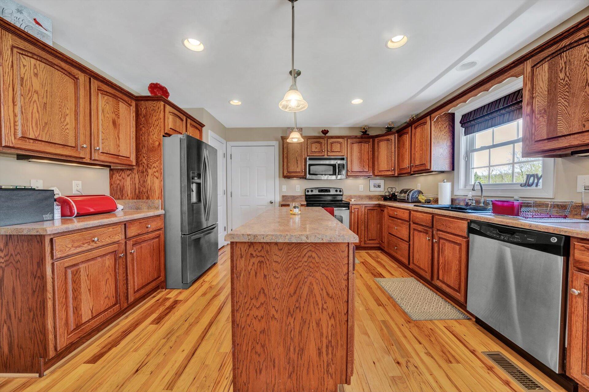 60 Green Level Road Boones Mill, VA 24065 - Photo 21 of 53 a large kitchen with stainless steel appliances lots of counter space and wooden floor