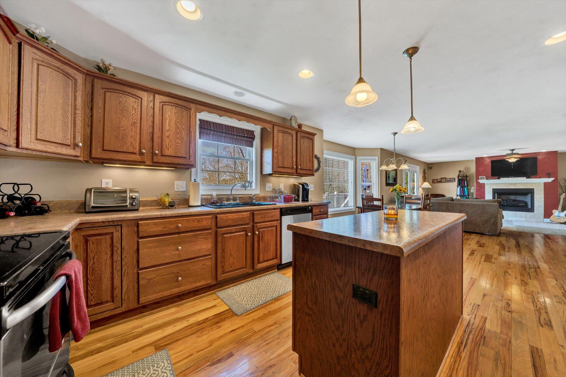 60 Green Level Road Boones Mill, VA 24065 - Photo 23 of 53 a kitchen with stainless steel appliances granite countertop a sink a stove and a wooden floors