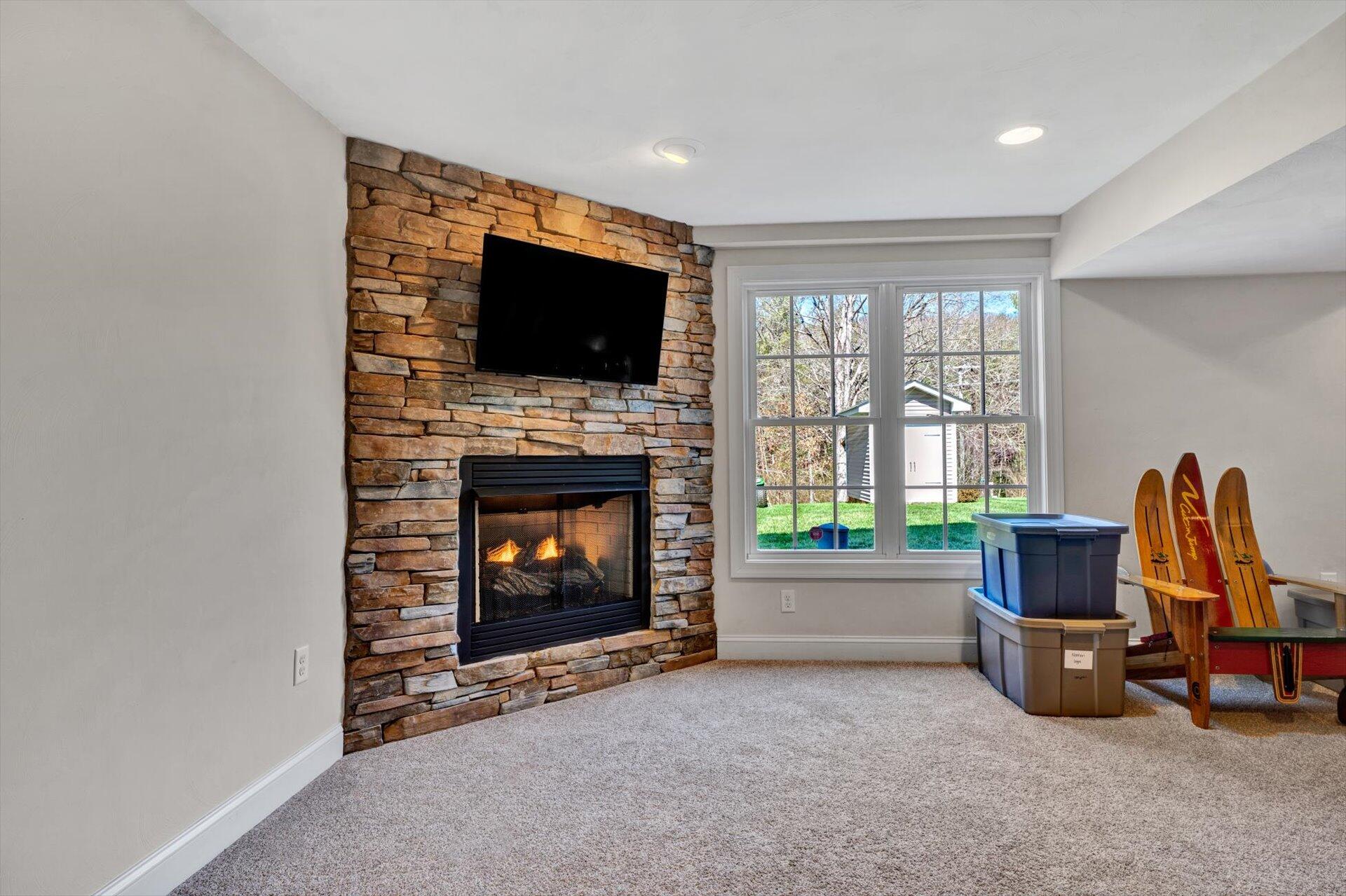 60 Green Level Road Boones Mill, VA 24065 - Photo 45 of 53 a living room with furniture a flat screen tv and a fireplace