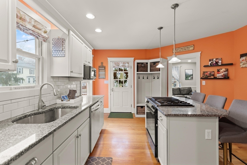 142 Railroad Avenue Hamilton, MA 01982 - Photo 11 of 29 a kitchen with stainless steel appliances granite countertop a sink a stove and a refrigerator