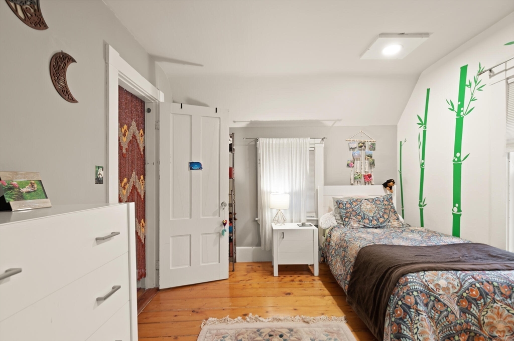 142 Railroad Avenue Hamilton, MA 01982 - Photo 22 of 29 a bedroom with a bed and a refrigerator