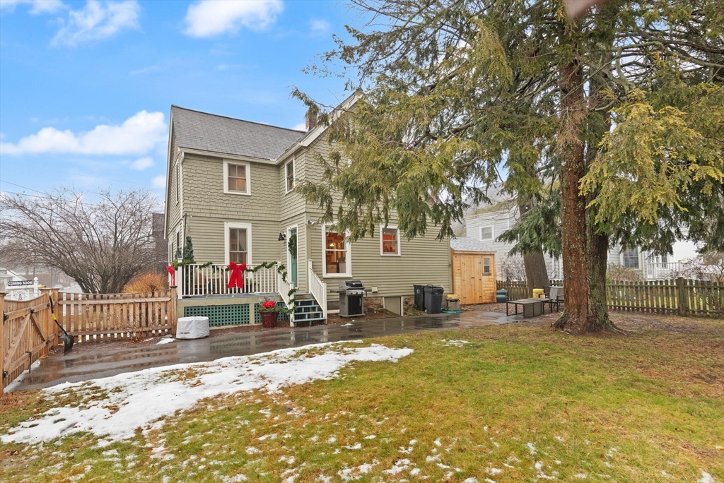142 Railroad Avenue Hamilton, MA 01982 - Photo 28 of 29 a view of a white house with a large tree and wooden fence