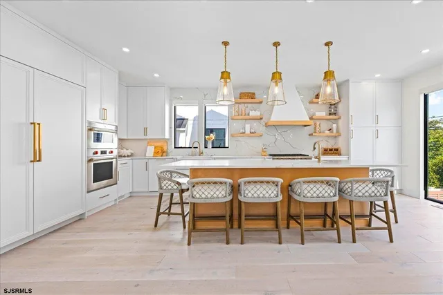 a bathroom with a toilet a sink a mirror and shower