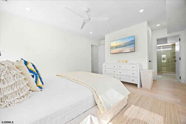 a bathroom with a shower a sink and a mirror