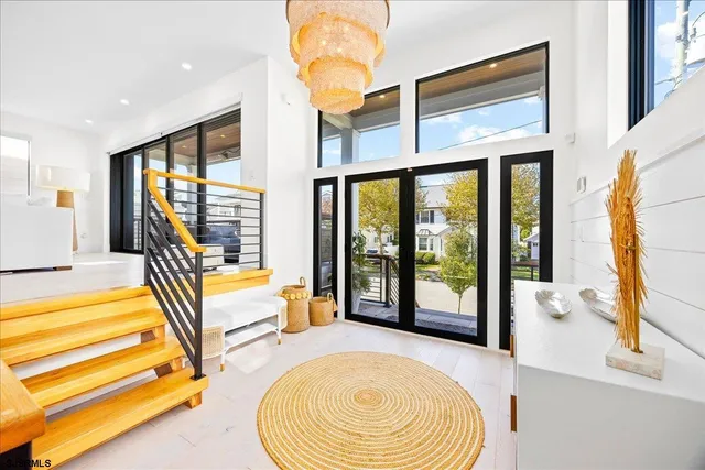 a living room with patio furniture and a potted plant