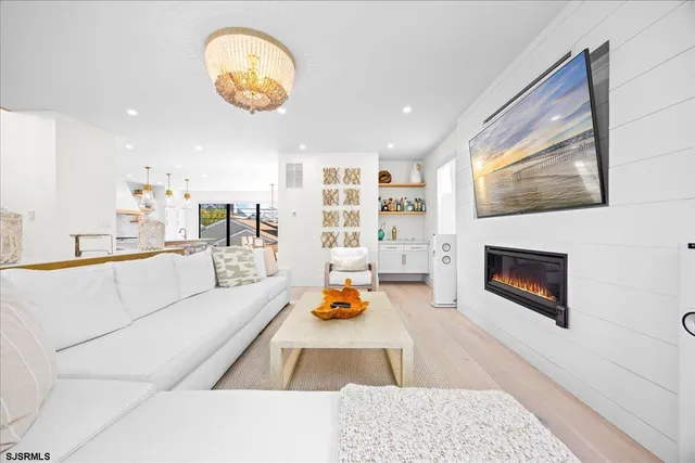 a dining hall with stainless steel appliances a dining table and chairs