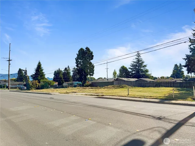 a view of a house with a swimming pool and a yard