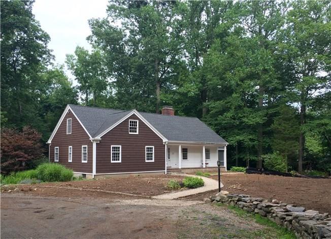 123 Weston Road Weston, CT 06883 - Photo 1 of 1 a front view of a house with a yard and large trees