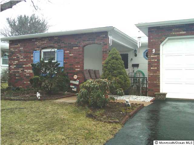 a view of a brick house with a yard