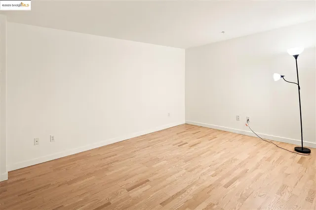 a bedroom with a bed and painting on the wall