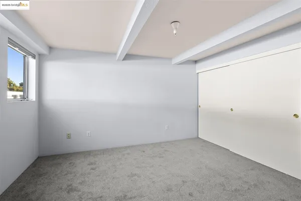 a bedroom with a bed and a car