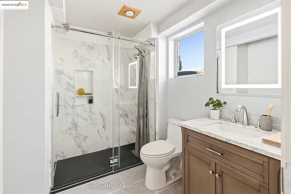 a view of kitchen with stainless steel appliances wooden floor and a window