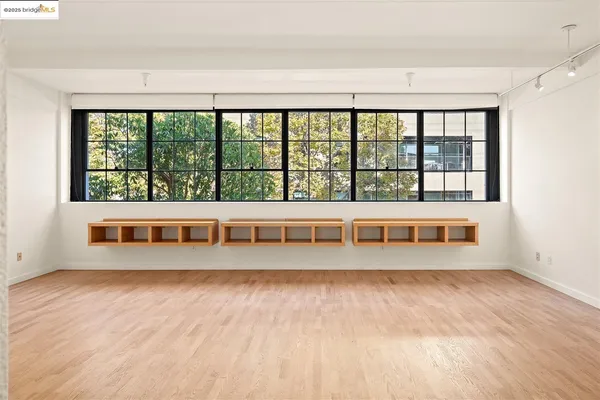 a view of a kitchen with wooden floor and a ceiling fan
