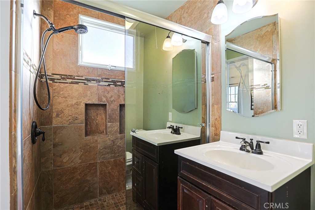 1014 Sheffield Street Santa Ana, CA 92703 - Photo 12 of 21 a bathroom with a sink vanity granite and a mirror