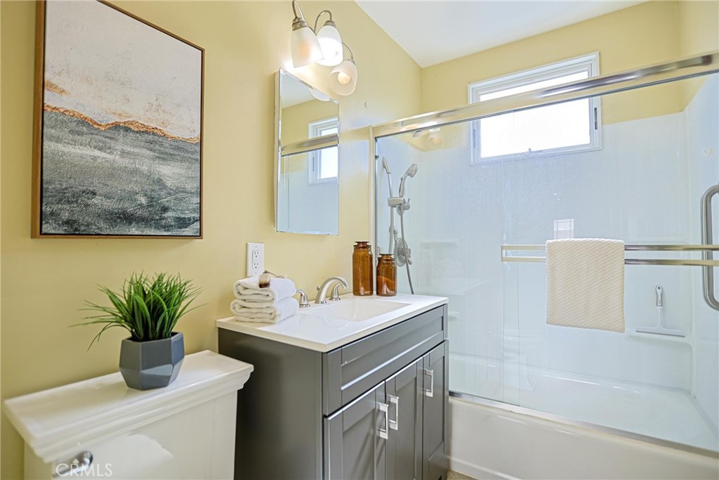 1014 Sheffield Street Santa Ana, CA 92703 - Photo 14 of 21 a bathroom with a sink a mirror and a shower