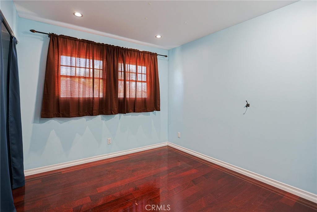 1014 Sheffield Street Santa Ana, CA 92703 - Photo 15 of 21 an empty room with wooden floor and windows