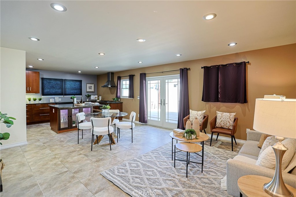 1014 Sheffield Street Santa Ana, CA 92703 - Photo 5 of 21 a living room with furniture and a dining table with kitchen view