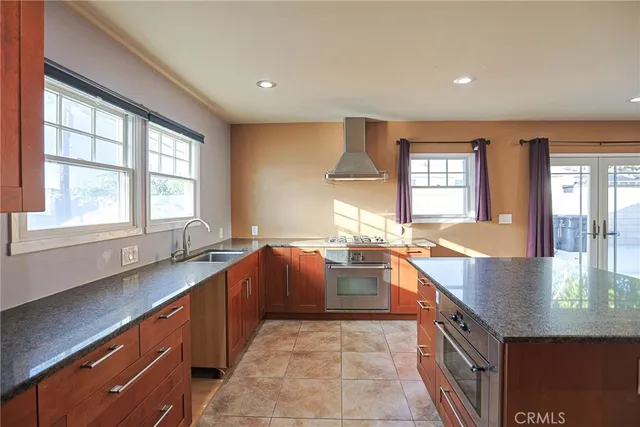 a large kitchen with granite countertop a sink and dishwasher with a large window