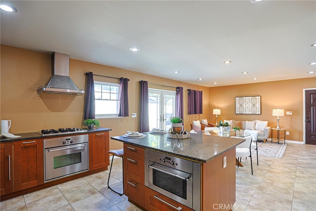1014 Sheffield Street Santa Ana, CA 92703 - Photo 7 of 21 a kitchen with a stove a sink and a refrigerator