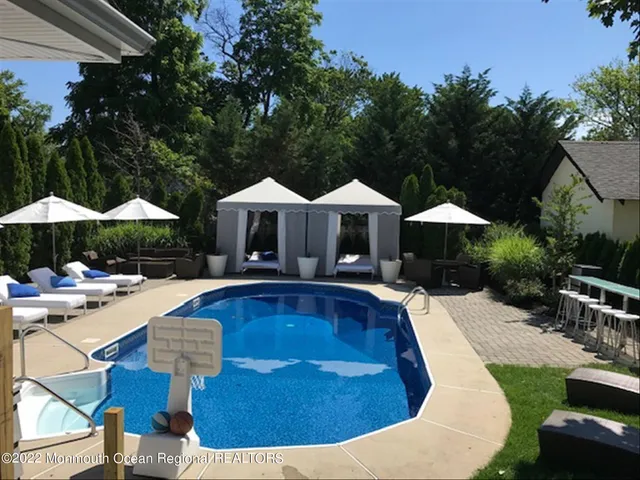 a view of swimming pool and lounge chair