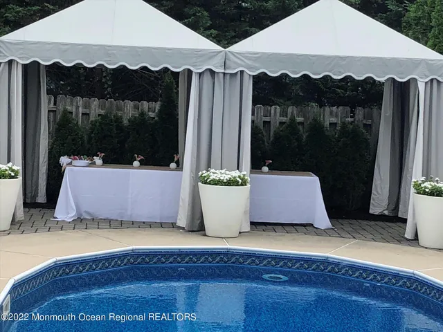 a white bath tub sitting in a bathroom next to a yard