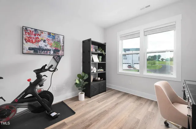 a view of a workspace with furniture and a window